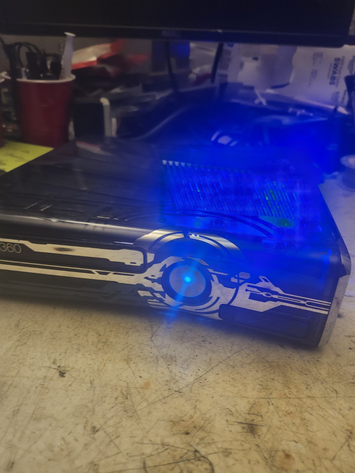 Actual Xbox 360 Halo 4 console powered-on blue LED side view